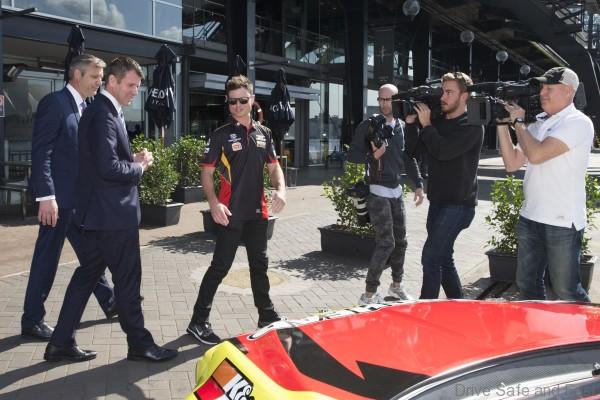 V8 Supercars drive Tim Slade shows the V8 Supercars CEO James Warburton and NSW Premier Mike Baird around his race car at the launch on Sydney Harbour ahead of Event 8 of the 2015 Australian V8 Supercars Championship Series at the Sydney Motor Sport Park , Sydney, New South Wales, August 19, 2015.