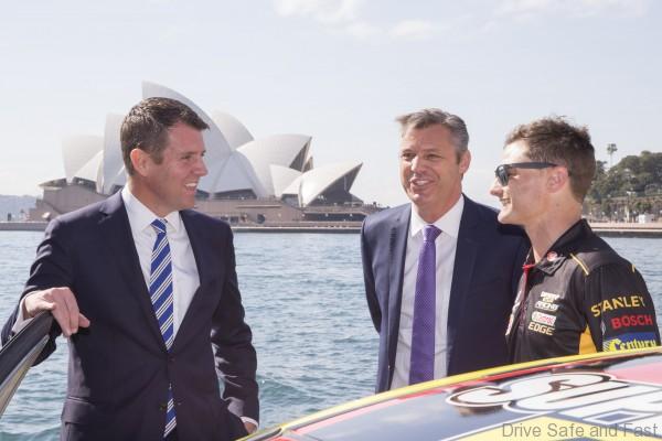 V8 Supercars drive Tim Slade talks with NSW Premier Mike Baird and V8 Supercars CEO James Warburton around his race car at the launch on Sydney Harbour ahead of Event 8 of the 2015 Australian V8 Supercars Championship Series at the Sydney Motor Sport Park , Sydney, New South Wales, August 19, 2015.