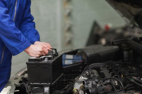 Mechanic changing car battery