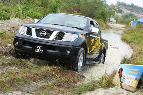 A Shell Helix contest finalist taking a Nissan Navarra through a water hazard_2