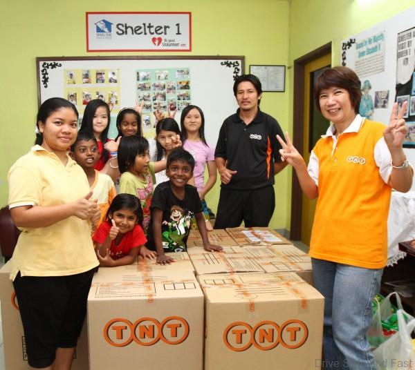 E.	Ms. Chook Chooi Khum, Manager of TNT HR, HSE & Corporate Responsibility, delivering the provisional items to the children and caretakers at Shelter Home.