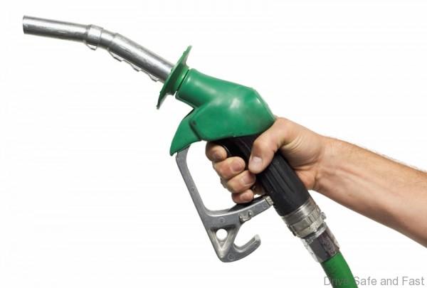 close up view of a hand holding a nozzle for fuel