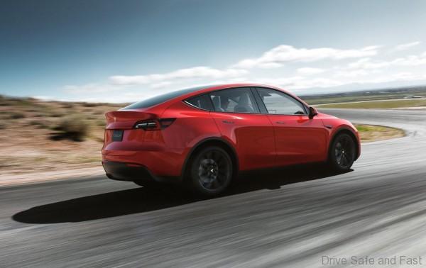 Tesla Model Y in motion, rear 3 quarter