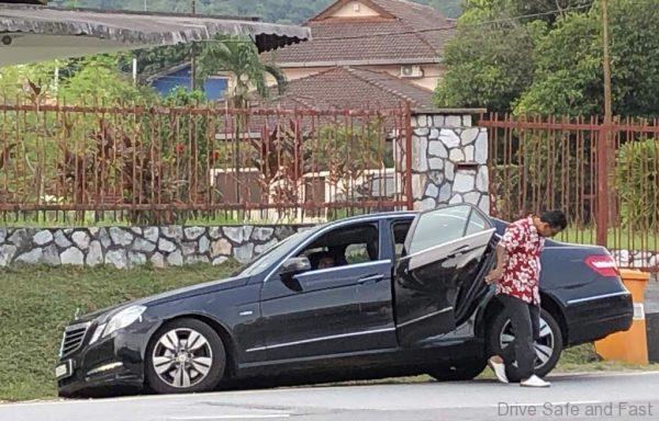 car in ditch avoiding pot hole