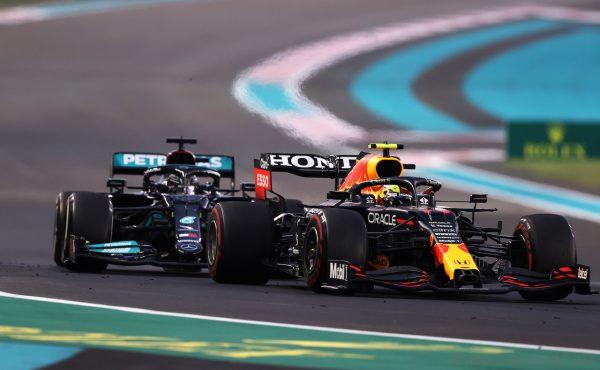ABU DHABI, UNITED ARAB EMIRATES - DECEMBER 12: Sergio Perez of Mexico driving the (11) Red Bull Racing RB16B Honda leads Lewis Hamilton of Great Britain driving the (44) Mercedes AMG Petronas F1 Team Mercedes W12 with Max Verstappen of the Netherlands driving the (33) Red Bull Racing RB16B Honda in the distance behind during the F1 Grand Prix of Abu Dhabi at Yas Marina Circuit on December 12, 2021 in Abu Dhabi, United Arab Emirates. (Photo by Lars Baron/Getty Images)