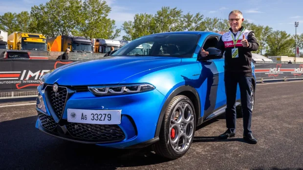CEO of Stellantis Carlos Tavares stands next to an Alfa Romeo Tonale